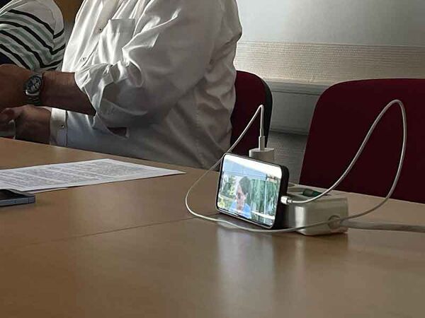 Ein Mitglied verfolgt die Generalversammlung der Marktzentrum Ranis eG per Online-Zuschaltung auf einem Smartphone. Die digitale Teilnahme ermöglicht auch weiter entfernt wohnenden Mitgliedern, sich aktiv an den Entscheidungen der Genossenschaft zu beteil